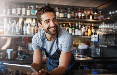 man working behind bar